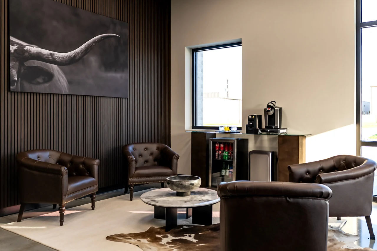 Client lounge in the Burrows Financial office lobby with leather chairs and longhorn artwork